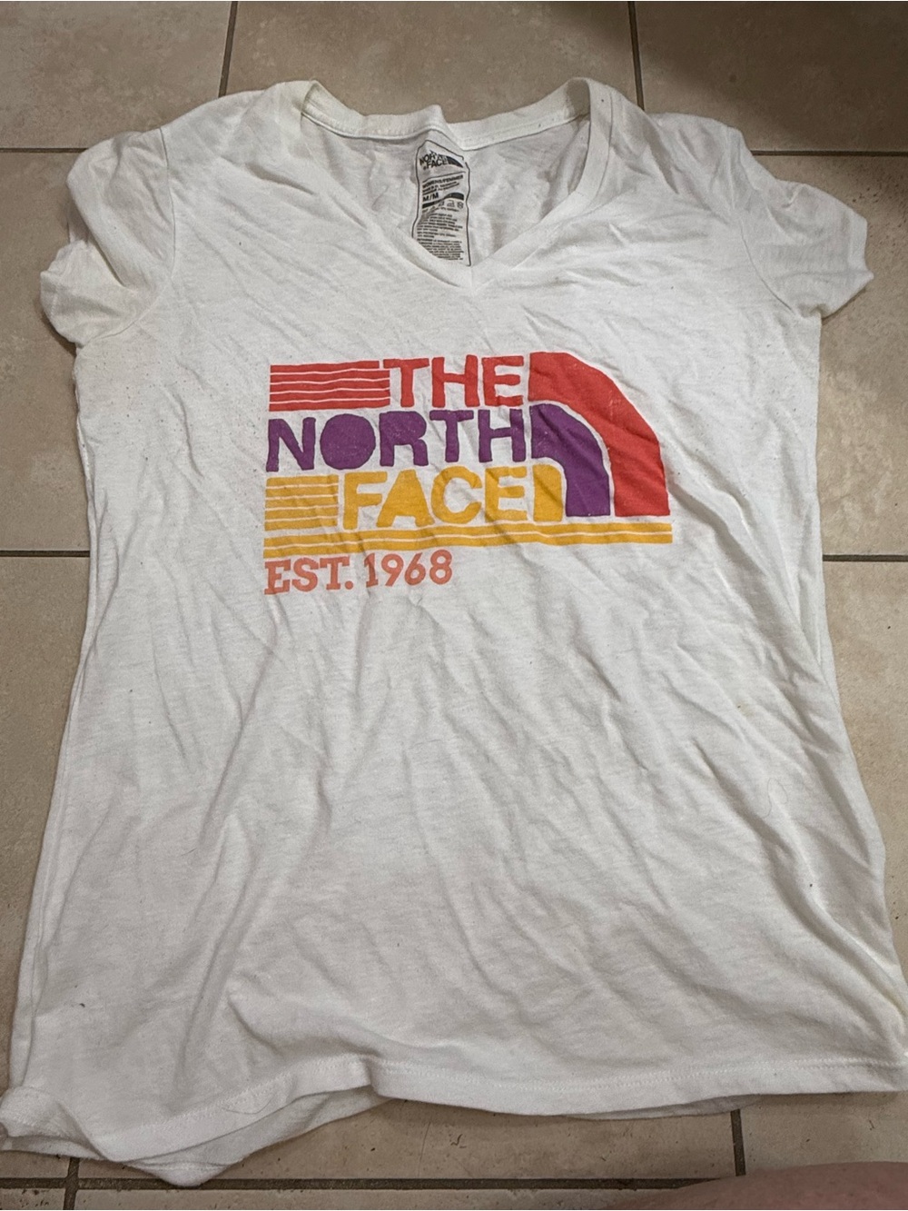 The North Face Women’s White V‑Neck Tee with Retro Multicolor Logo